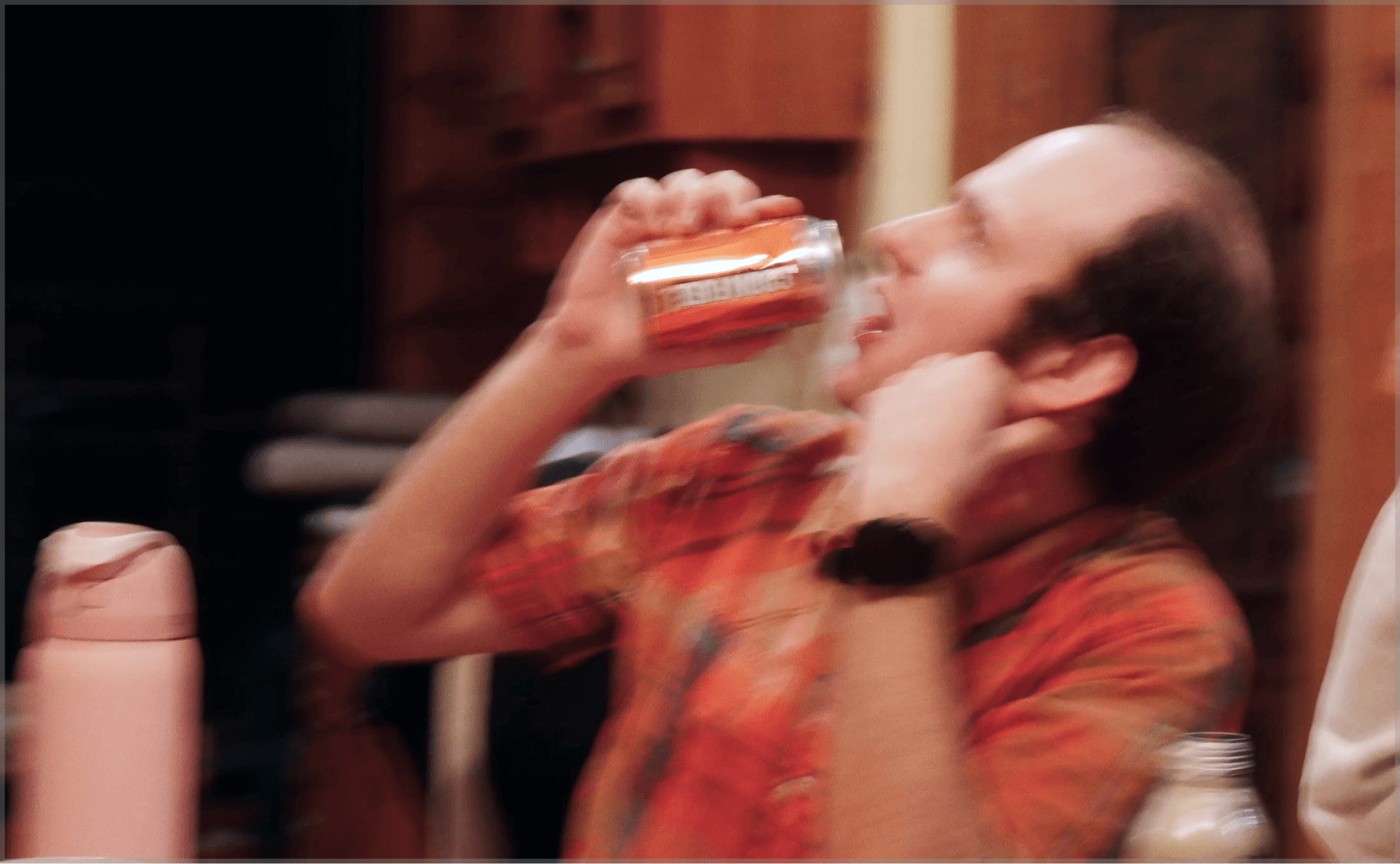 Artem drinking a canned beverage