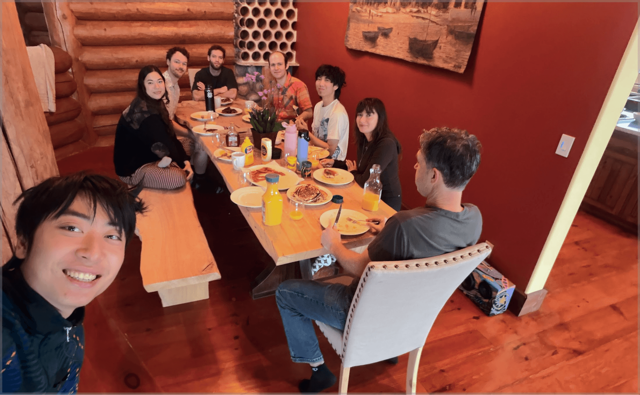 Team sitting around a dining table enjoying a meal